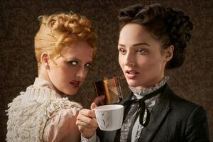 Two Beautiful Woman Holding Ceramic Mug