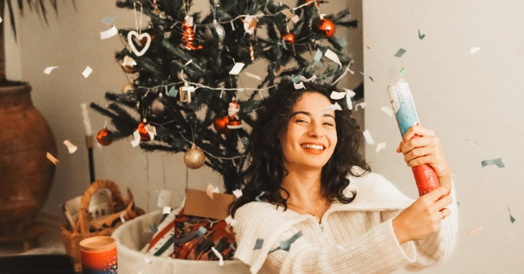 Smiling Woman Shooting Confetti Cannon Sitting in the Living Room by the Christmas Tree