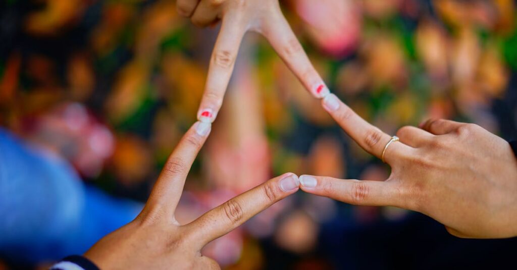 Close-up of hands forming a star shape, symbolizing unity and friendship.